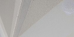 Basement wall with waterproof coating, water beading off.